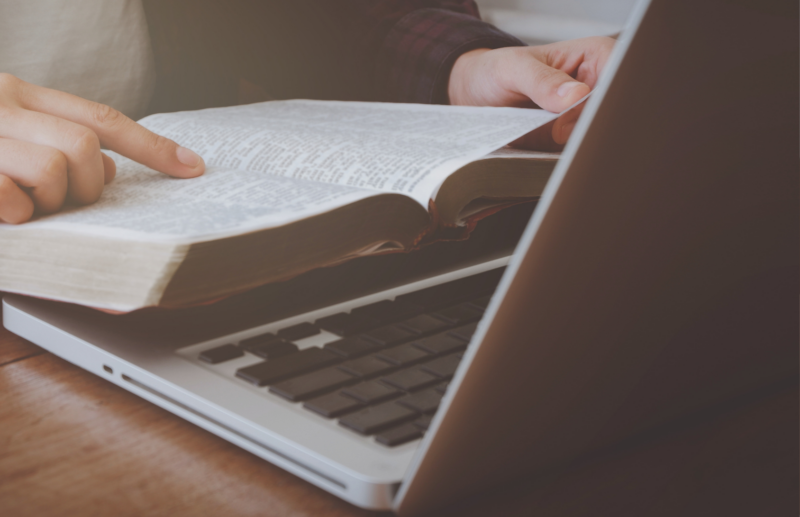 Faith based business owner reading bible while working